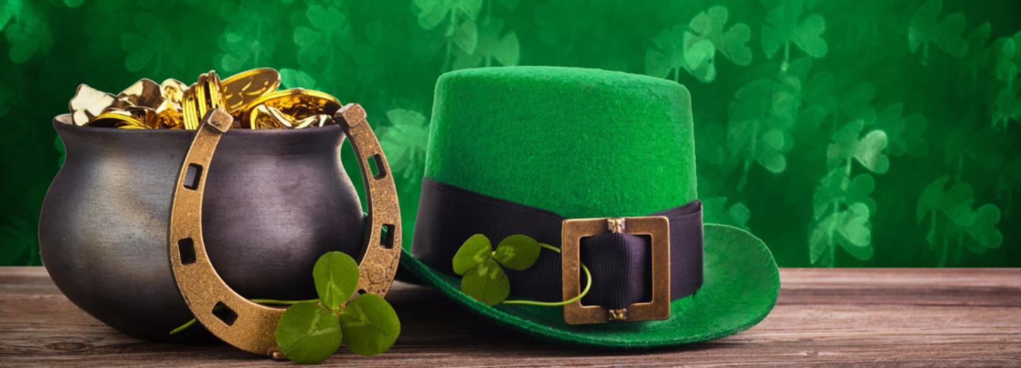 A pot of gold, horse shoe, clover, and St. Patty's Day hat