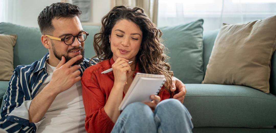 A happy couple discussing finances.