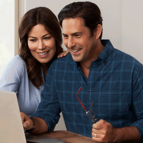 Couple looking at their taxes on a laptop.