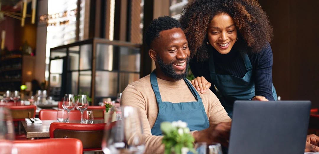Small business owners looking over their accounts